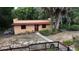 Exterior view of a guesthouse featuring a stucco exterior, red tile roof, and a well-maintained yard at 308 Sunnyside Dr, Leesburg, FL 34748