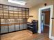 A kitchen with custom shelving, stainless steel oven, and mosaic backsplash, with rustic wood floors at 308 Sunnyside Dr, Leesburg, FL 34748