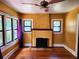 Cozy living room featuring a decorative fireplace, hardwood floors, and plenty of natural light at 308 Sunnyside Dr, Leesburg, FL 34748