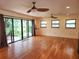 Open floor plan with wood floors, sliding glass doors, recessed lighting, and ceiling fans at 308 Sunnyside Dr, Leesburg, FL 34748