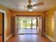 Bright living room with wooden floors, ceiling fan, and French doors to the backyard at 308 Sunnyside Dr, Leesburg, FL 34748