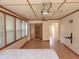 Bedroom with multiple ceiling fans and an adjacent closet and bathroom at 308 Sunnyside Dr, Leesburg, FL 34748
