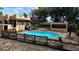 Backyard with fenced pool, a screened-in lanai, and a tranquil outdoor living space at 308 Sunnyside Dr, Leesburg, FL 34748