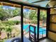 View from screened porch to the pool, backyard, and landscaping at 308 Sunnyside Dr, Leesburg, FL 34748