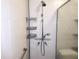 A tiled shower stall featuring modern fixtures, a shower head, and a removable shower head at 308 Sunnyside Dr, Leesburg, FL 34748