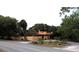 Charming home featuring a stucco exterior, a red tile roof, and a gated entrance near the street at 308 Sunnyside Dr, Leesburg, FL 34748