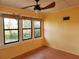 Cozy sunroom with multiple windows offering lots of natural light and wood-look floors at 308 Sunnyside Dr, Leesburg, FL 34748