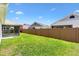 A well-manicured backyard with a lush green lawn and a privacy fence provides an inviting outdoor living space at 3118 Sweetgum St, The Villages, FL 32163