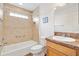 Full bathroom with tiled shower, tub, and vanity at 3118 Sweetgum St, The Villages, FL 32163