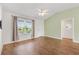 Bright bedroom with wood floors, a large window, and a ceiling fan at 3118 Sweetgum St, The Villages, FL 32163