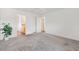 Spacious bedroom features neutral carpet, ceiling fan, and an open doorway to an en-suite bathroom at 3118 Sweetgum St, The Villages, FL 32163
