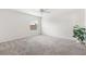 Bright bedroom with neutral carpet, a ceiling fan, and a large window offering plenty of natural light at 3118 Sweetgum St, The Villages, FL 32163