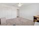 Bright bedroom with neutral carpet, a ceiling fan, and closet at 3118 Sweetgum St, The Villages, FL 32163