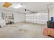 Spacious two-car garage with an automatic door, ample room for storage, and a clean, well-maintained concrete floor at 3118 Sweetgum St, The Villages, FL 32163