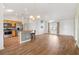 Open-concept living room featuring hardwood floors, a skylight, and abundant natural light at 3118 Sweetgum St, The Villages, FL 32163