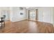 Bright living room featuring wood floors, large window, and front door at 3118 Sweetgum St, The Villages, FL 32163