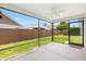 A screened-in patio features a ceiling fan and provides views of the backyard with a well-maintained lawn and privacy fence at 3118 Sweetgum St, The Villages, FL 32163