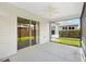A screened-in patio features a ceiling fan and sliding door, providing a seamless transition to the outdoor living space at 3118 Sweetgum St, The Villages, FL 32163