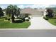 Aerial front elevation view of a well-maintained home with a paved driveway and manicured landscaping at 3177 Williams Rd, The Villages, FL 32162