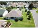 Well maintained backyard with lush green grass, manicured garden beds, and screened in porch at 3177 Williams Rd, The Villages, FL 32162