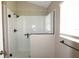 Bathroom with frameless glass shower, black fixtures, and window with privacy blinds at 3177 Williams Rd, The Villages, FL 32162