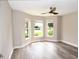 Bedroom with hardwood floors, neutral paint, ceiling fan, and bay window offering natural light at 3177 Williams Rd, The Villages, FL 32162