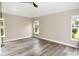 Bright bedroom with hardwood floors, neutral paint, and double windows with natural light at 3177 Williams Rd, The Villages, FL 32162