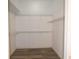 Walk-in closet with wire shelving and wood-look flooring at 3177 Williams Rd, The Villages, FL 32162
