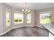 Cozy dining area with bright windows and modern chandelier at 3177 Williams Rd, The Villages, FL 32162