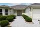 Charming front entrance features a paved walkway and manicured shrubbery at 3177 Williams Rd, The Villages, FL 32162