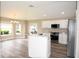 Modern kitchen features granite countertops, white cabinets, and stainless steel appliances at 3177 Williams Rd, The Villages, FL 32162