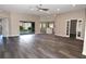 Spacious living room with luxury vinyl plank flooring, fan, recessed lighting, and sliding glass doors to the lanai at 3177 Williams Rd, The Villages, FL 32162