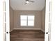 Bright office with luxury vinyl plank flooring, fresh paint, crown molding, and a large window at 3177 Williams Rd, The Villages, FL 32162