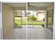 Covered patio with tile flooring and views of the landscaped backyard with lawn at 3177 Williams Rd, The Villages, FL 32162