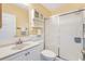 Clean bathroom featuring a vanity with storage, commode, and shower with sliding doors at 3472 Roanoke St, The Villages, FL 32162