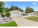 Inviting single-Gathering home with a white picket fence and attached one-car garage at 3472 Roanoke St, The Villages, FL 32162