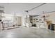 Spacious garage with laundry machines, utility sink, storage cabinets, and ample shelving for organization at 3472 Roanoke St, The Villages, FL 32162