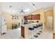 Well-lit kitchen featuring a breakfast bar with seating, modern appliances, and a dining area at 3472 Roanoke St, The Villages, FL 32162
