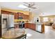 Modern kitchen open to the living area with stainless appliances and tile floors at 3472 Roanoke St, The Villages, FL 32162