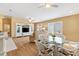 Cozy living room with wood floors, plush furniture, and a view towards the kitchen and dining area at 3472 Roanoke St, The Villages, FL 32162