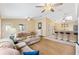Spacious living area with comfortable sofas, ceiling fans, and natural light from the windows at 3472 Roanoke St, The Villages, FL 32162