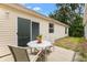Inviting outdoor patio with comfortable seating area and sliding glass door access to the home at 3472 Roanoke St, The Villages, FL 32162