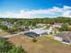 Aerial view of a home showcasing the screened pool, fenced yard, and surrounding neighborhood at 3731 Peaceful Valley Dr, Clermont, FL 34711