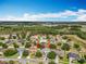 An aerial view showcasing the property's location within a residential neighborhood and lush green surroundings at 3731 Peaceful Valley Dr, Clermont, FL 34711