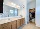 Bathroom featuring a double sink vanity, framed mirror, tile flooring and walk-in closet at 3731 Peaceful Valley Dr, Clermont, FL 34711