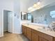 Bathroom showcasing double sinks, tile flooring, large mirror and walk-in shower at 3731 Peaceful Valley Dr, Clermont, FL 34711