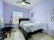 Bedroom with a black bed frame, tile floors, window, ceiling fan, and a desk at 3731 Peaceful Valley Dr, Clermont, FL 34711