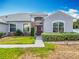 Close-up of the home's front door with stone facade and manicured bushes at 3731 Peaceful Valley Dr, Clermont, FL 34711
