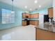 The kitchen features wood cabinets, granite countertops, and tile flooring at 3731 Peaceful Valley Dr, Clermont, FL 34711