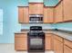 This kitchen is well equipped with a range, microwave, and granite counter tops at 3731 Peaceful Valley Dr, Clermont, FL 34711